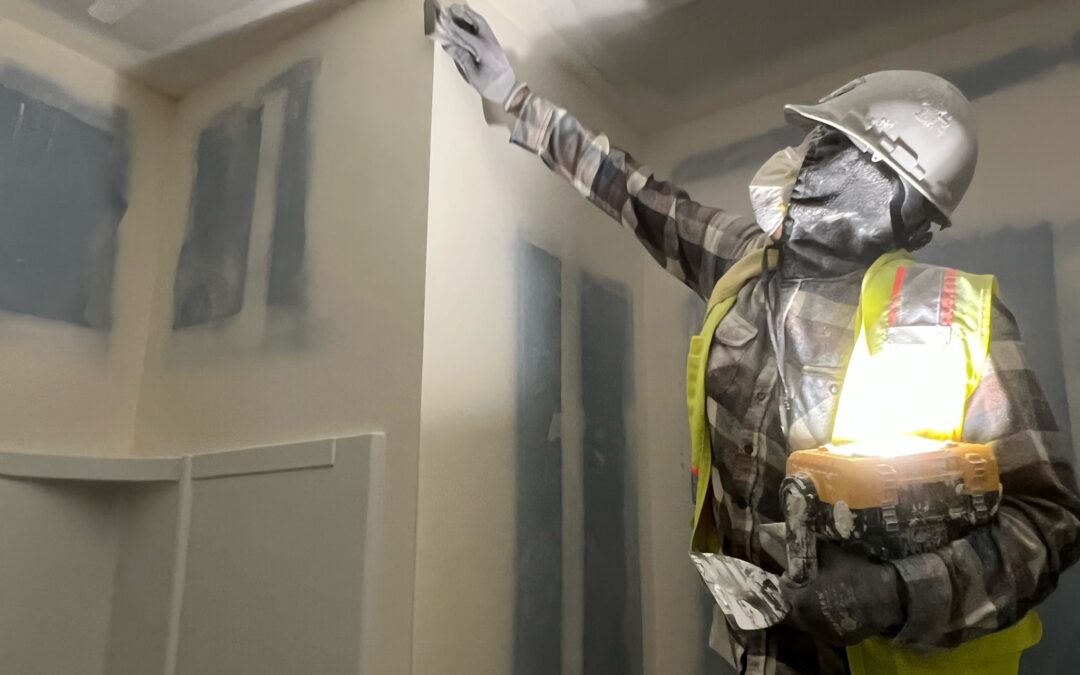 A member of the Magnum team is installing plaster on a job site. Learn what plaster is here!